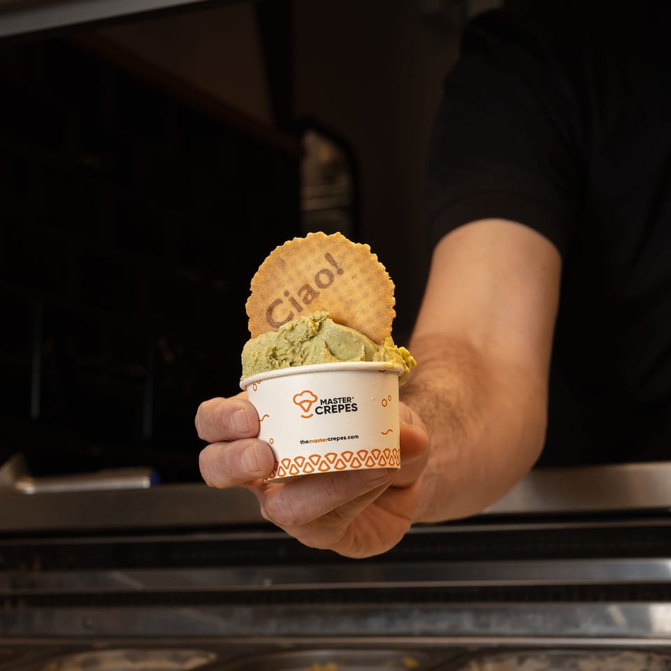 Gelato in a Master Crepes cup topped with a Ciao wafer